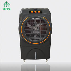 A black portable industrial air cooler with a circular front grille, orange accent rings, and three orange control buttons on top, shown on a light gray background with a DC/12V logo in the top-left corner.